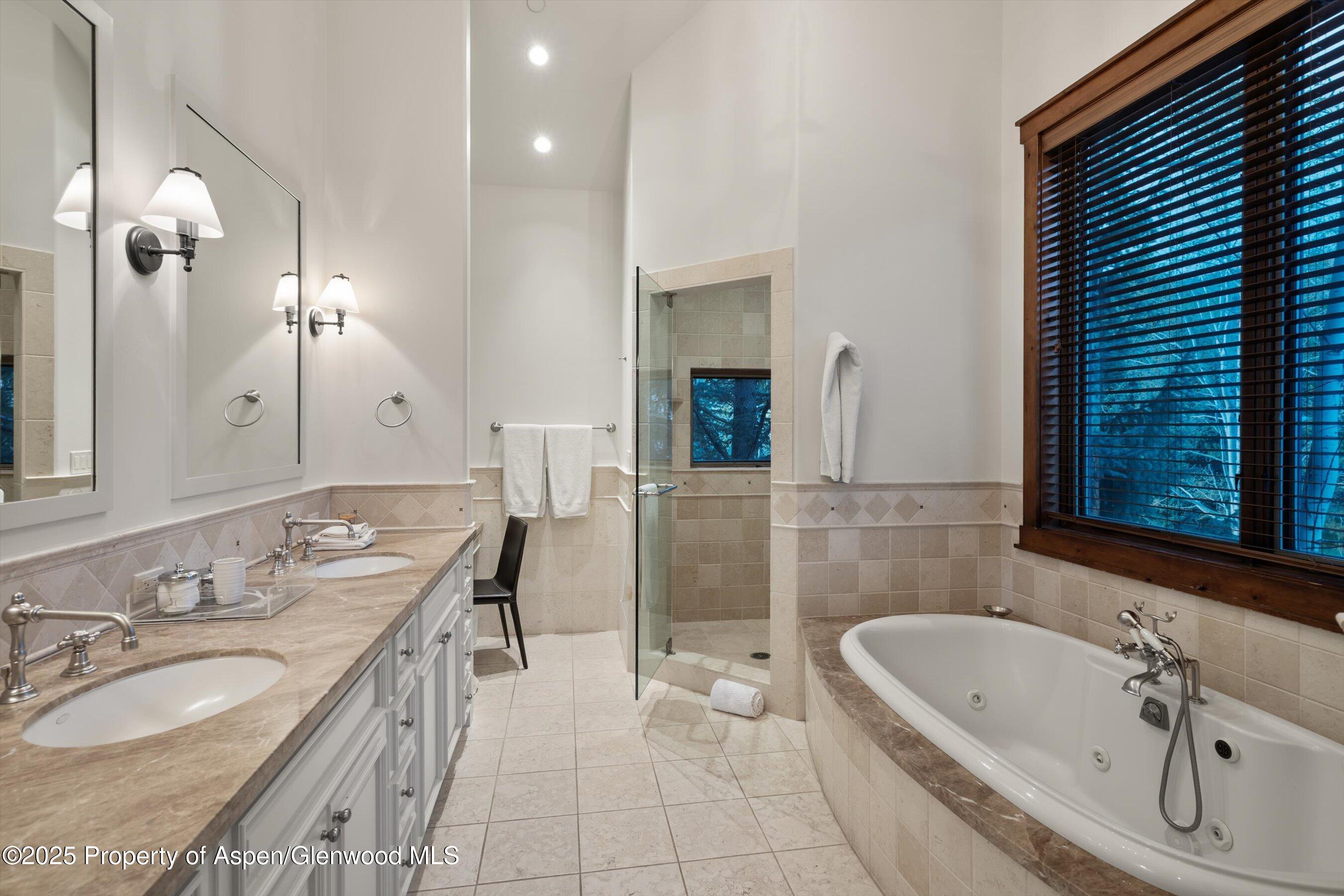 1430 Sierra Vista Drive Aspen, CO 81611 - Photo 23 of 57 a spacious bathroom with a granite countertop tub sink and mirror