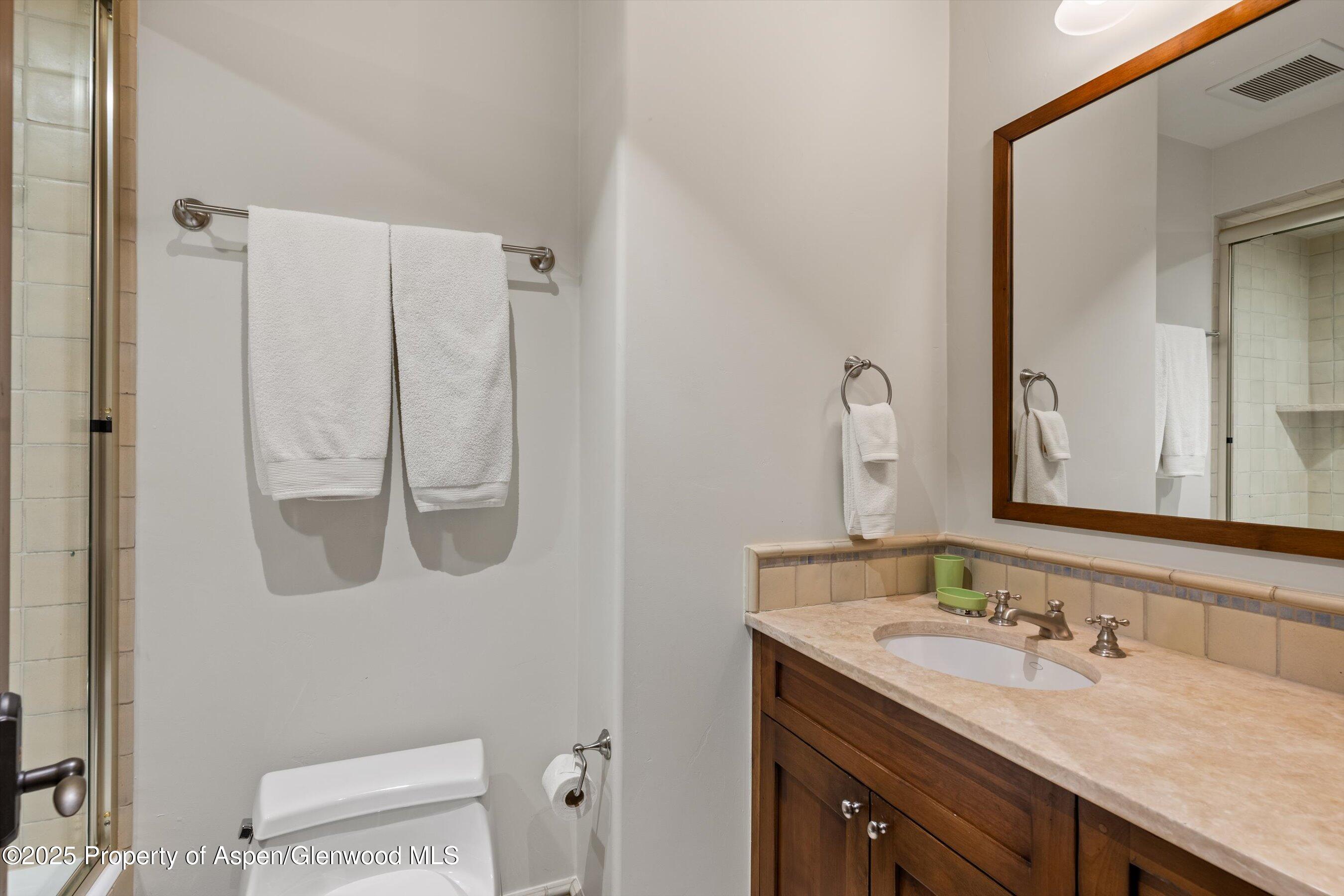 1430 Sierra Vista Drive Aspen, CO 81611 - Photo 25 of 57 a bathroom with a granite countertop sink and a mirror