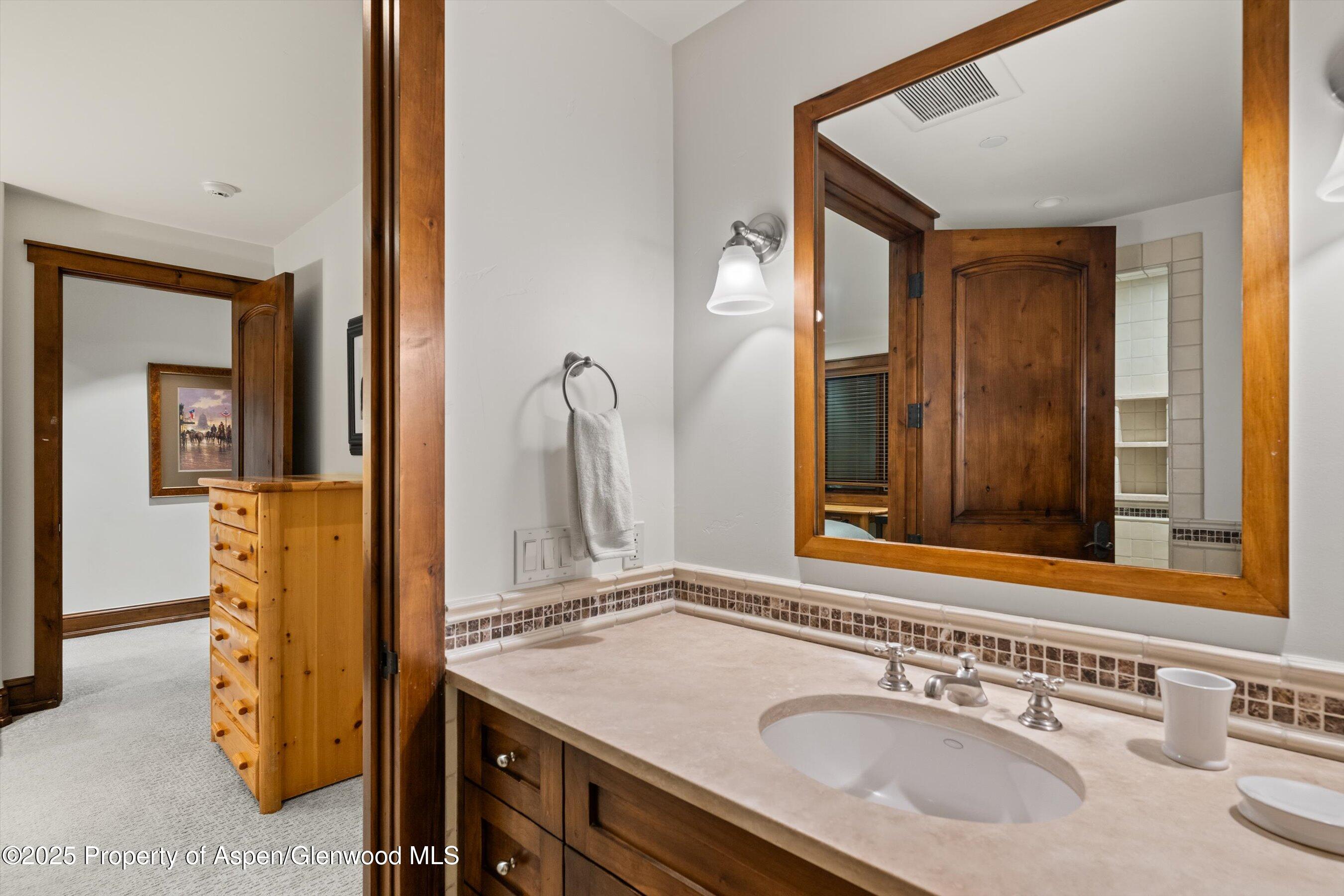 1430 Sierra Vista Drive Aspen, CO 81611 - Photo 26 of 57 a bathroom with a sink and a mirror