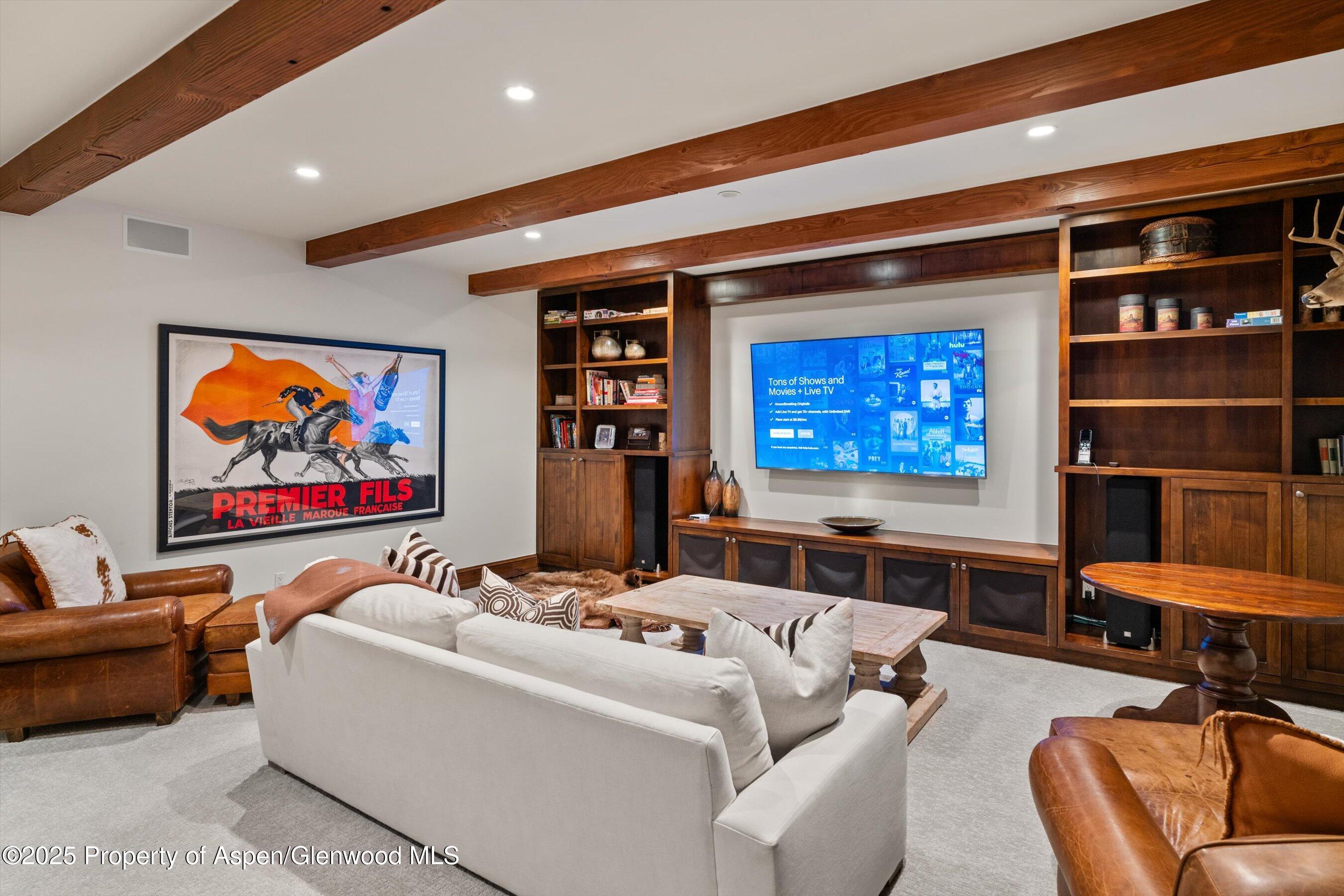 1430 Sierra Vista Drive Aspen, CO 81611 - Photo 37 of 57 a living room with furniture a rug and a projector with kitchen view