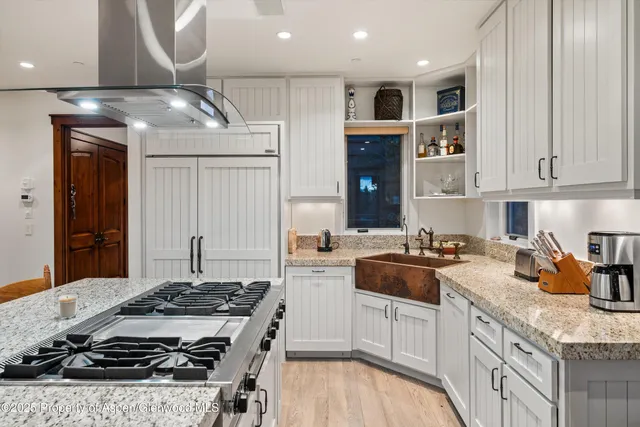 a kitchen with a stove a sink and a refrigerator