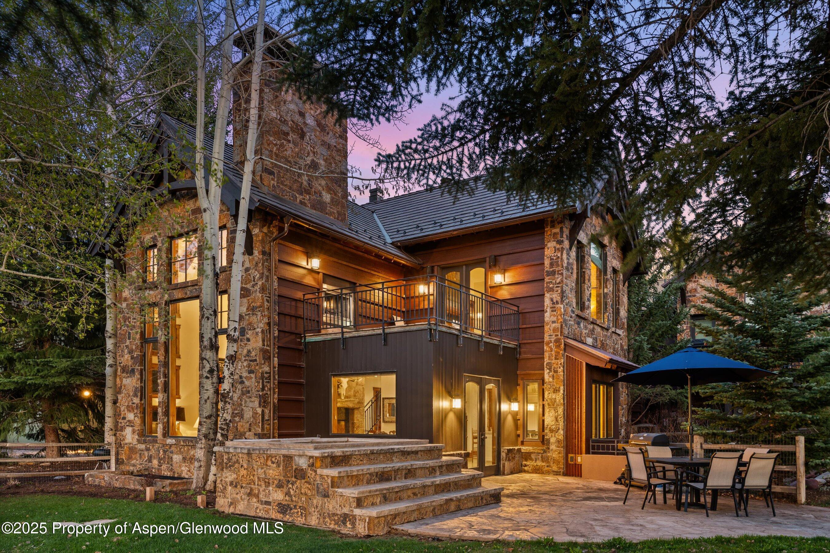 1430 Sierra Vista Drive Aspen, CO 81611 - Photo 42 of 57 a view of a cafe with a table and chairs under an umbrella
