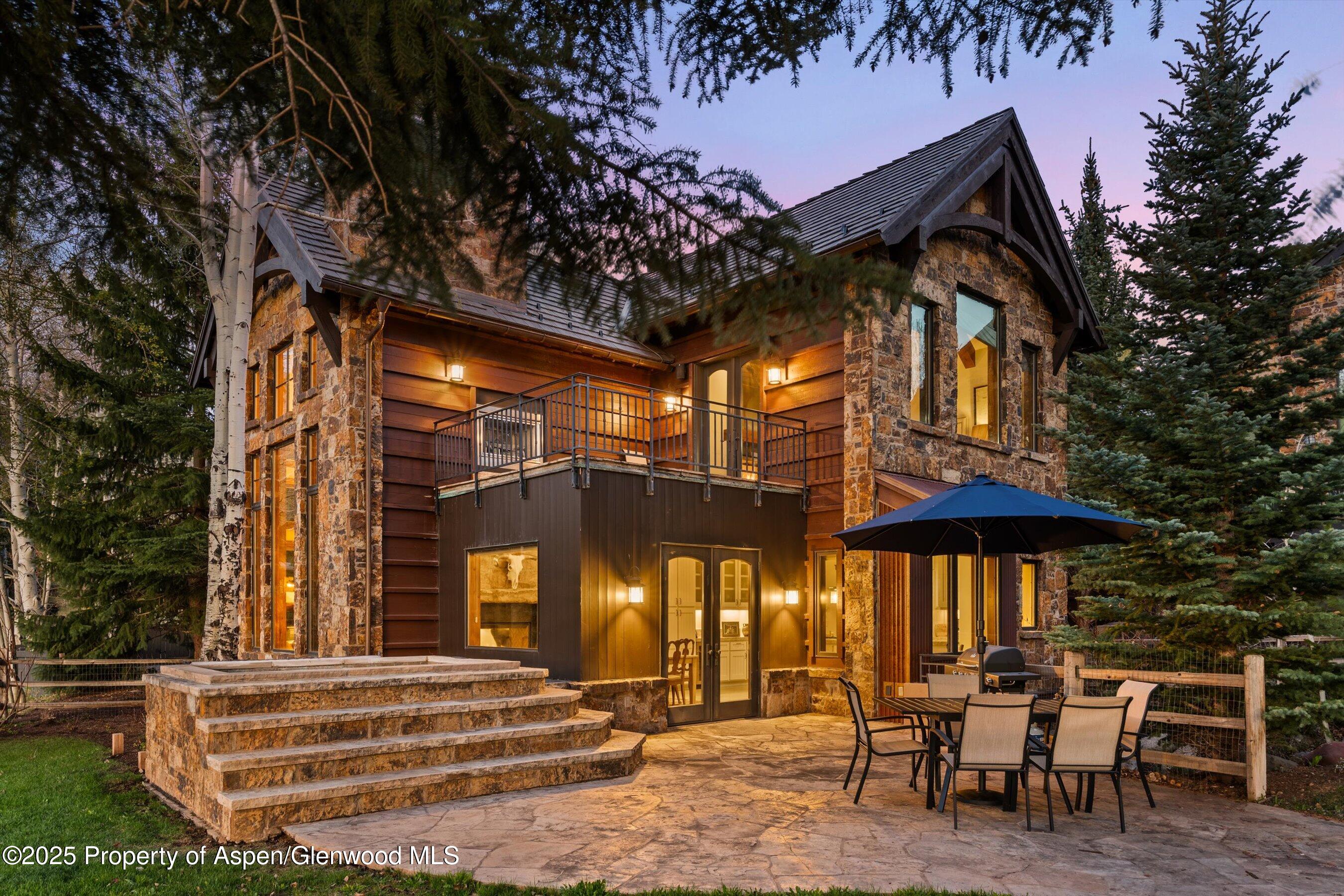 1430 Sierra Vista Drive Aspen, CO 81611 - Photo 44 of 57 a backyard of a house with barbeque oven table and chairs