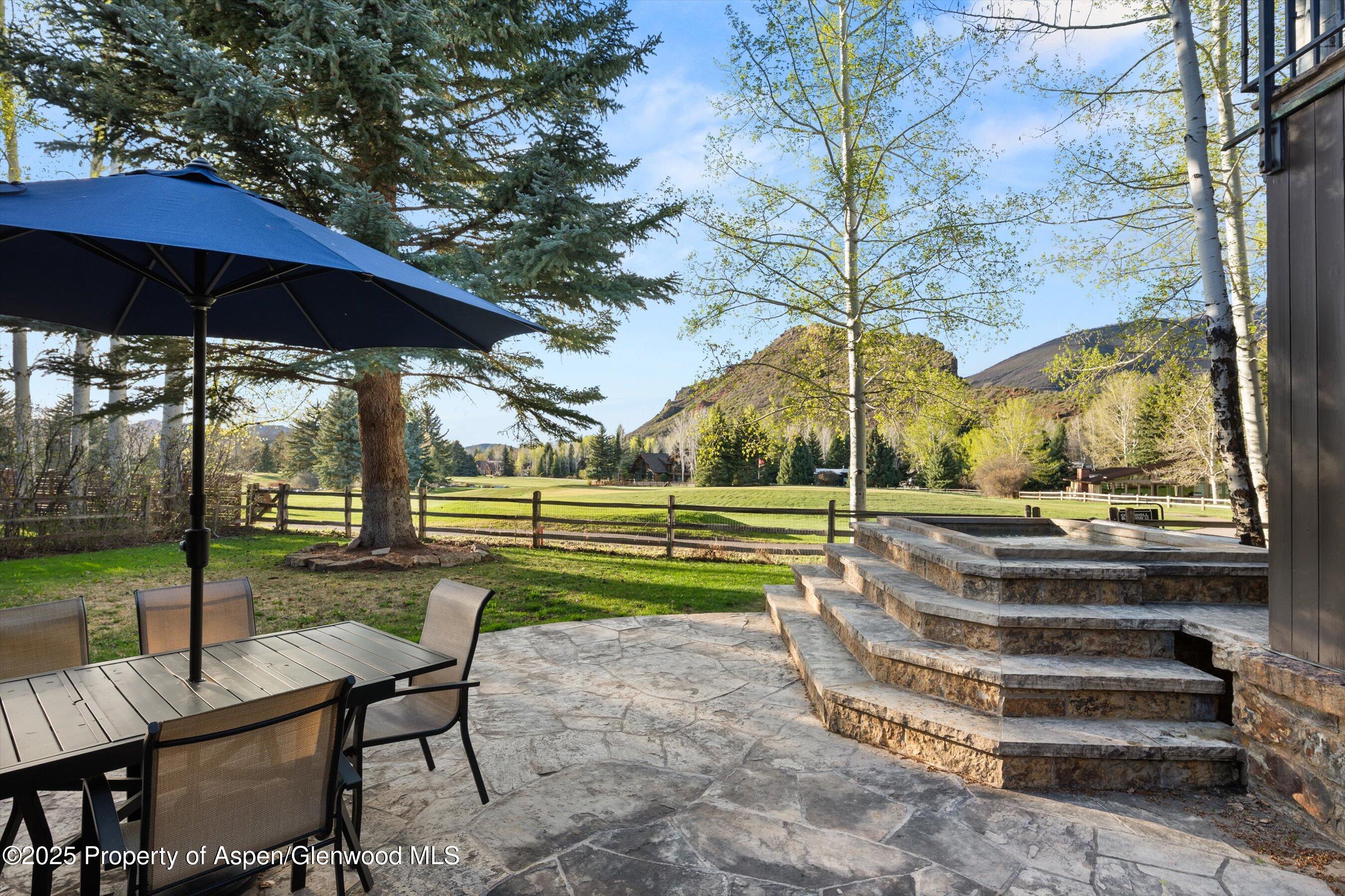 1430 Sierra Vista Drive Aspen, CO 81611 - Photo 46 of 57 a view of a table and chairs under an umbrella