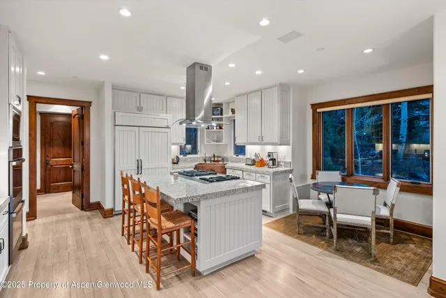 a view of a dining room with furniture and chandelier