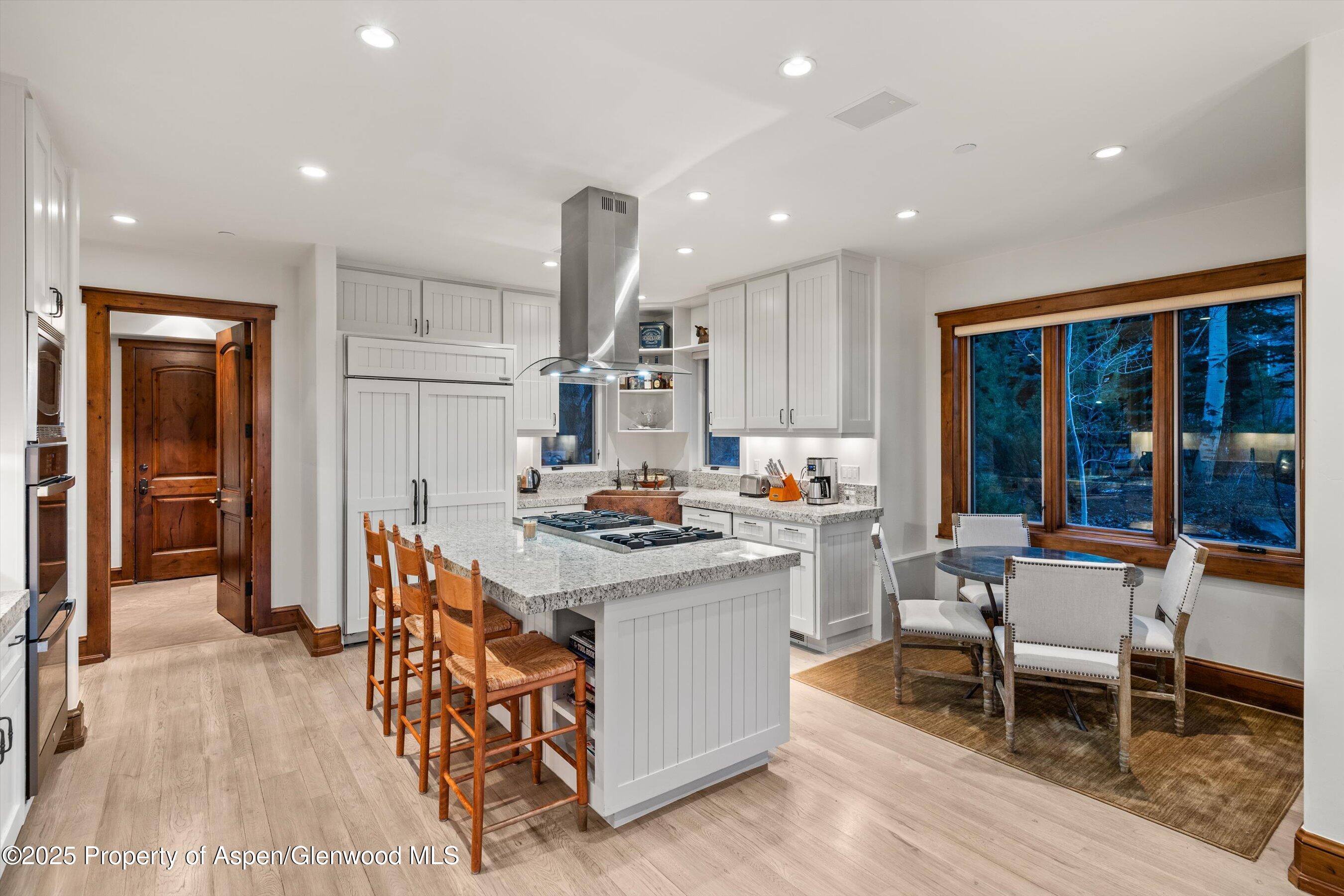 1430 Sierra Vista Drive Aspen, CO 81611 - Photo 6 of 57 a kitchen with stainless steel appliances granite countertop table chairs sink and cabinets