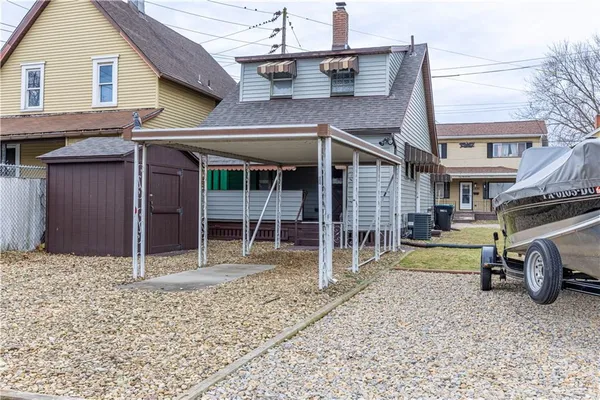 a view of a house with a patio and a yard