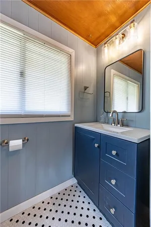 a bathroom with a sink mirror and a vanity