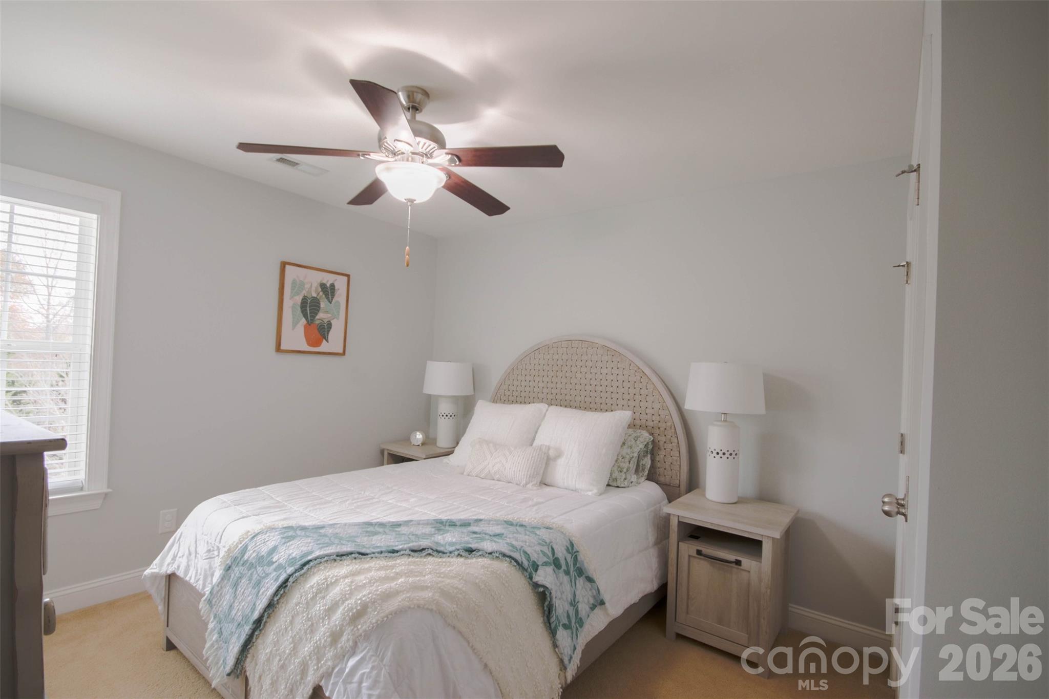 4030 Sunset Ridge Drive Rock Hill, SC 29732 - Photo 24 of 39 a bedroom with a bed and a chandelier