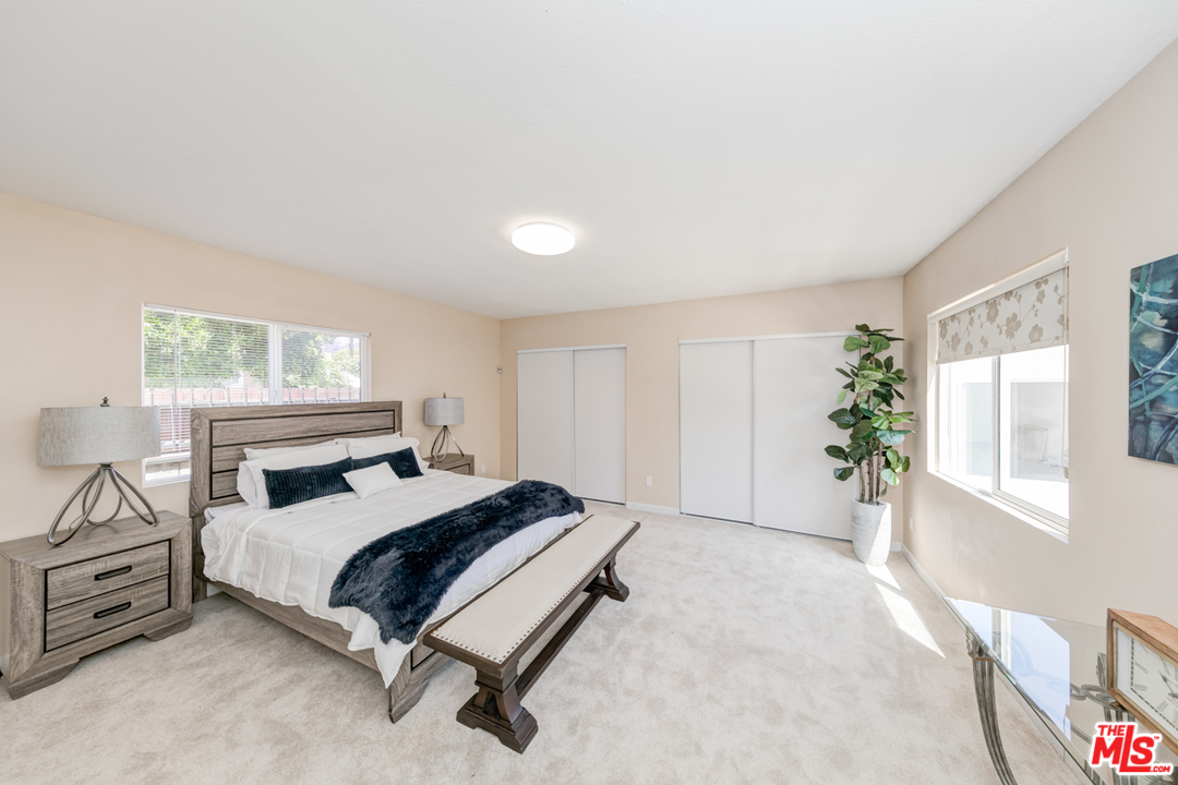2816 Virginia Road Los Angeles, CA 90016 - Photo 12 of 29 a bedroom with a bed next to a window with potted plants