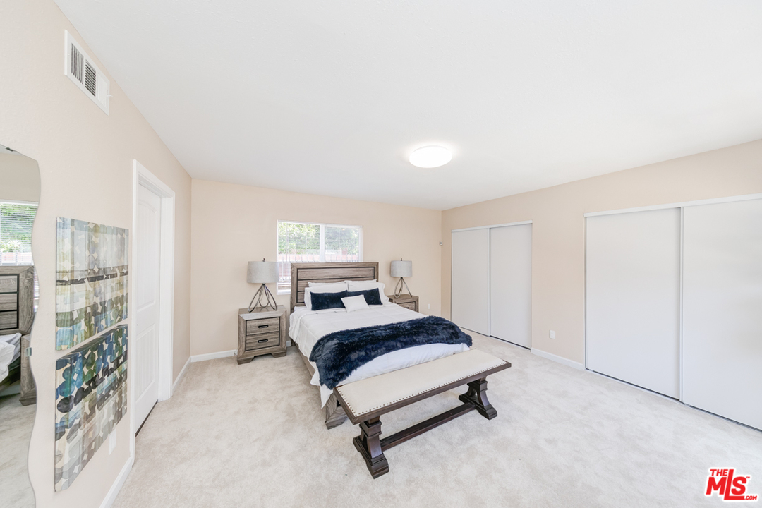 2816 Virginia Road Los Angeles, CA 90016 - Photo 13 of 29 a bedroom with a bed lamp on desk and a window