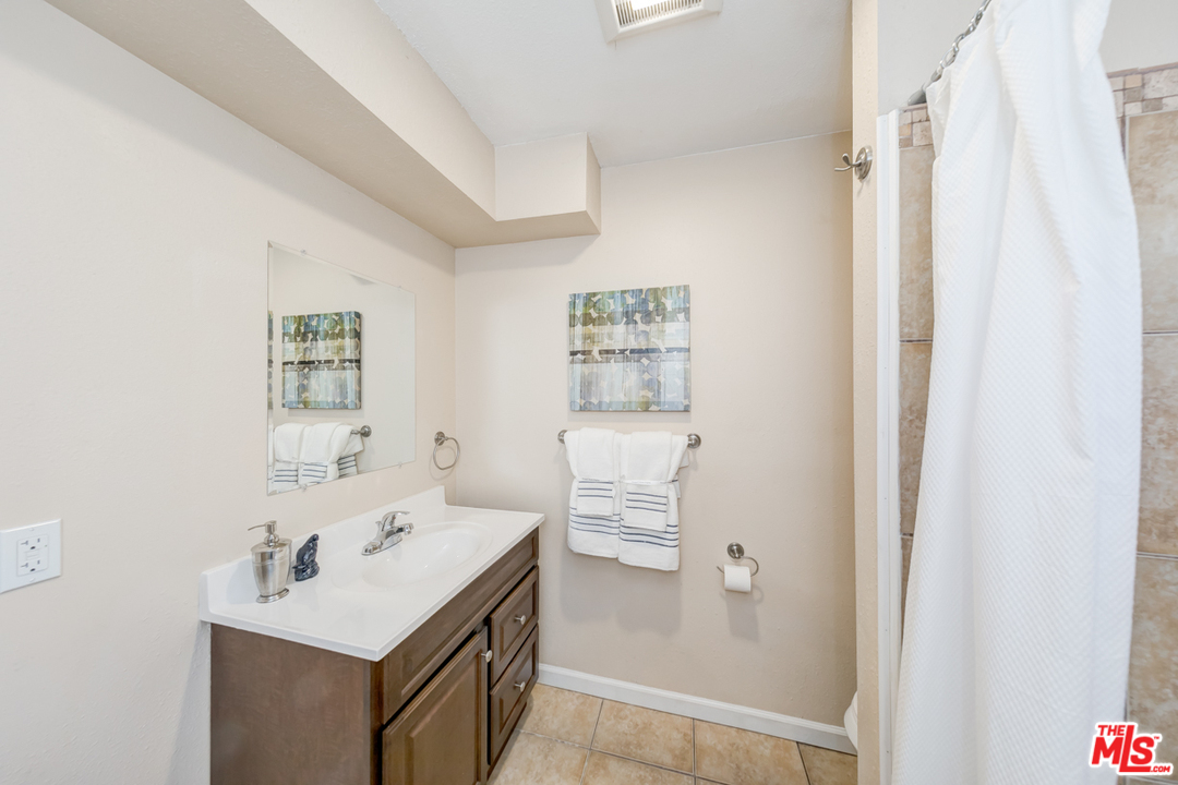 2816 Virginia Road Los Angeles, CA 90016 - Photo 14 of 29 a bathroom with a sink a toilet and a mirror