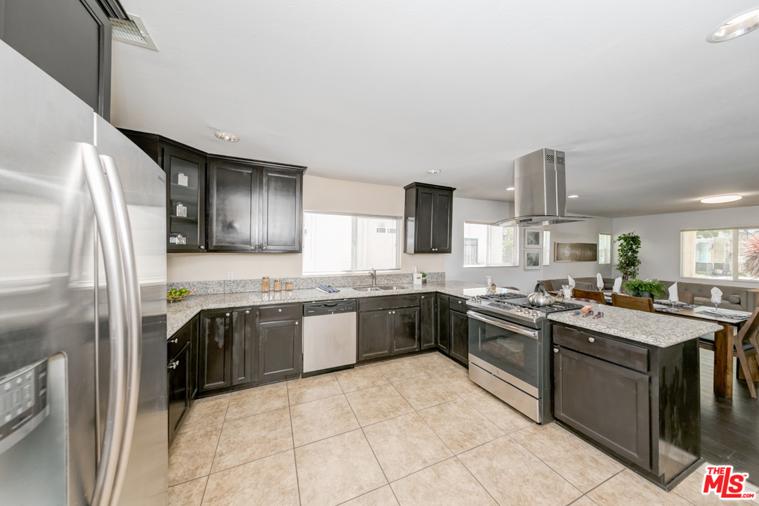 2816 Virginia Road Los Angeles, CA 90016 - Photo 9 of 29 a kitchen with stainless steel appliances granite countertop a stove top oven sink and refrigerator