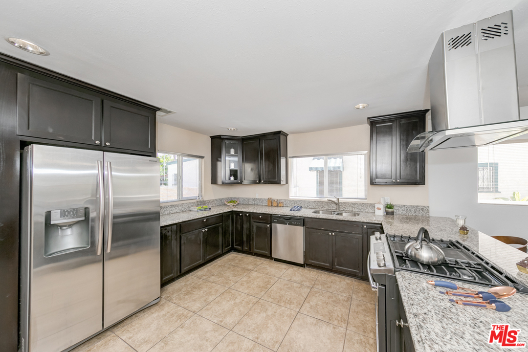 2816 Virginia Road Los Angeles, CA 90016 - Photo 10 of 29 a modern kitchen with stainless steel appliances granite countertop a refrigerator and a sink