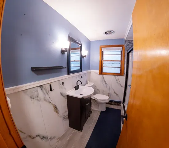 a bathroom with a sink mirror and a bathtub