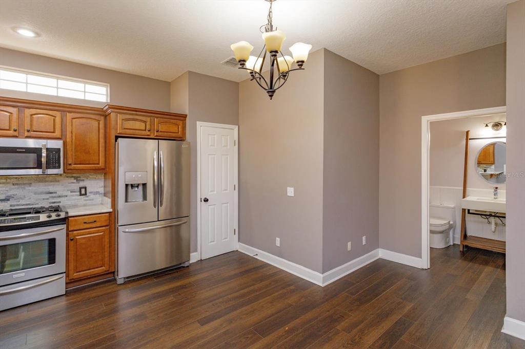 41 East Spruce Street Orlando, FL 32804 - Photo 11 of 24 a kitchen with stainless steel appliances granite countertop a refrigerator and a stove top oven