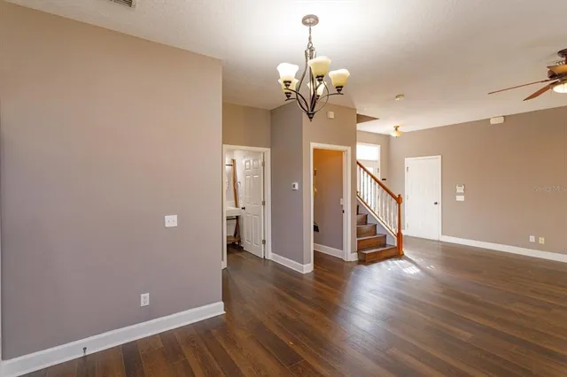 a view of a room with wooden floor and staircase
