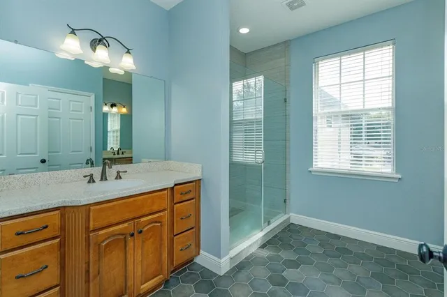 a bathroom with a sink double vanity and a mirror