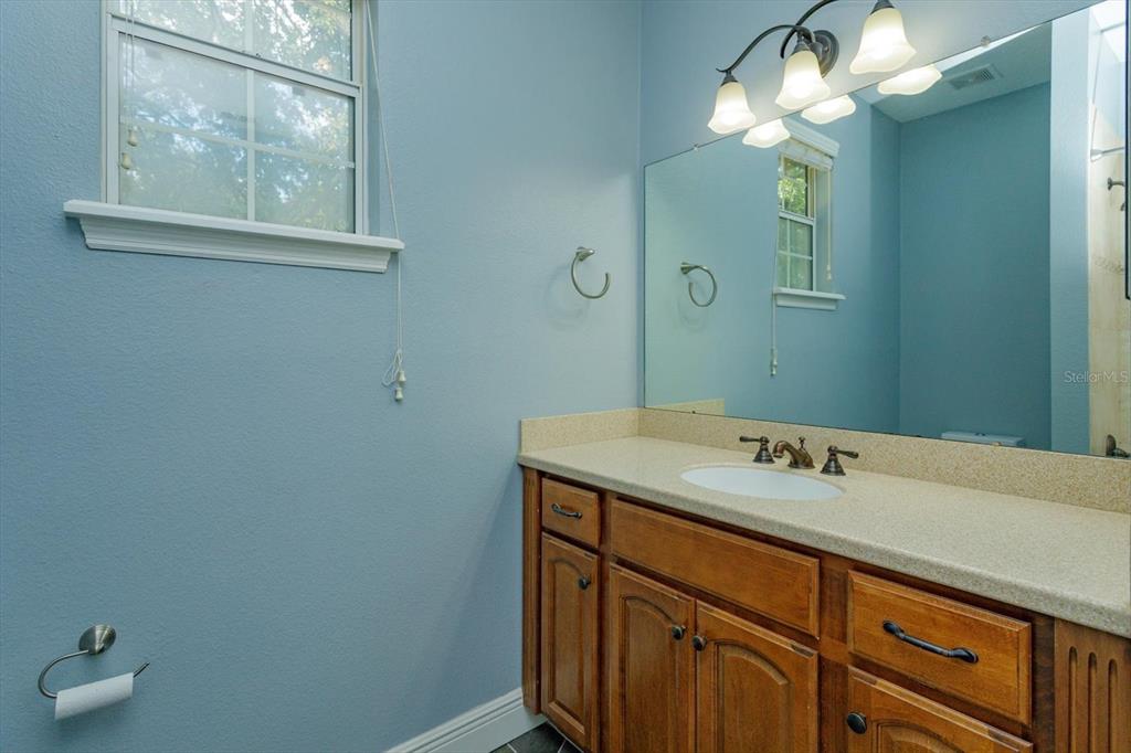 41 East Spruce Street Orlando, FL 32804 - Photo 17 of 24 a bathroom with a sink and a mirror