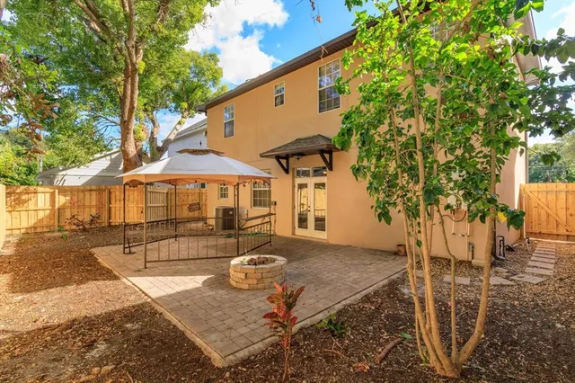 a backyard of a house with table and chairs