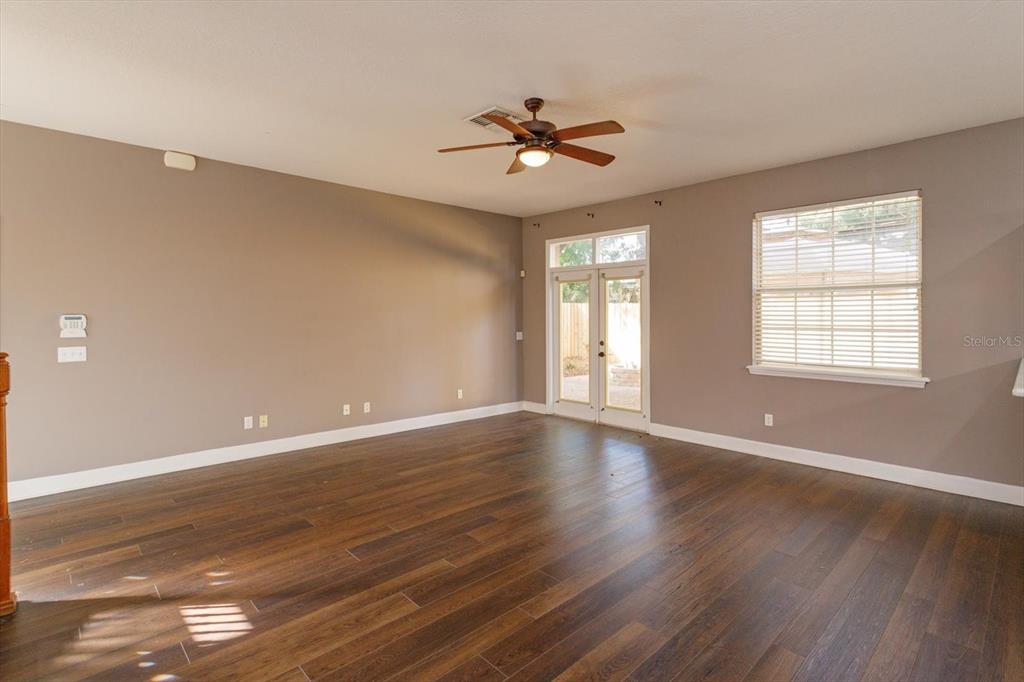 41 East Spruce Street Orlando, FL 32804 - Photo 6 of 24 a view of an empty room with wooden floor and a window