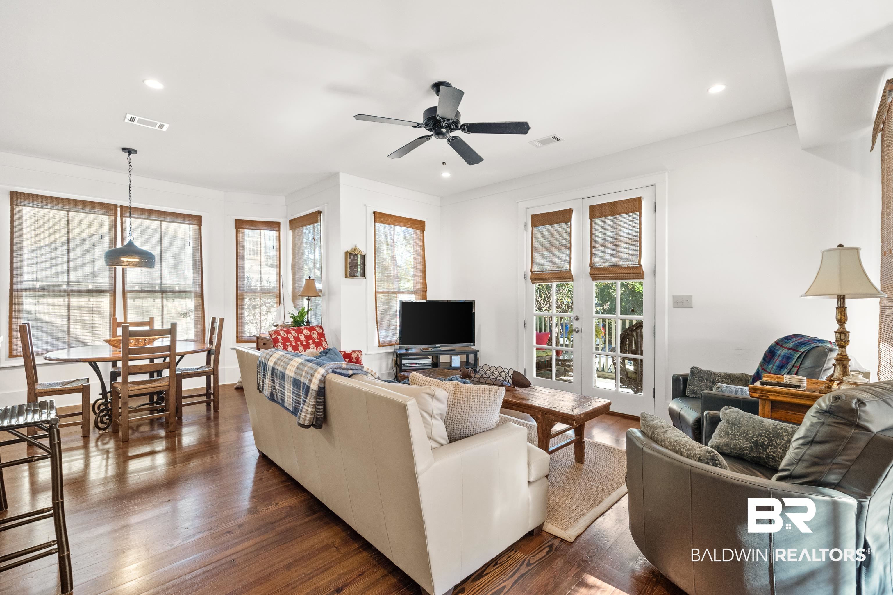 25773 Canal Road, Unit 10 Orange Beach, AL 36561 - Photo 4 of 40 Living room with beautiful hardwood floors, a healthy amount of sunlight, ceiling fan, and french doors