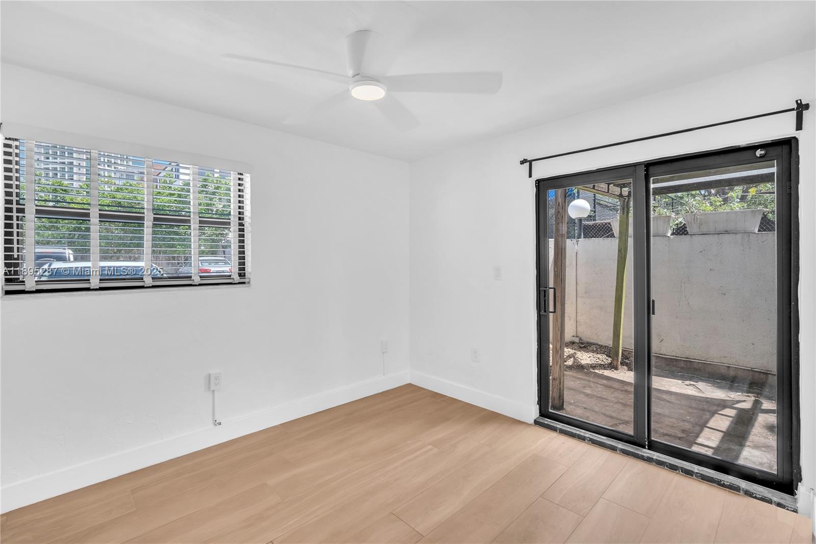3265 Virginia Street, Unit 8 Miami, FL 33133 - Photo 11 of 24 a view of an empty room with glass door