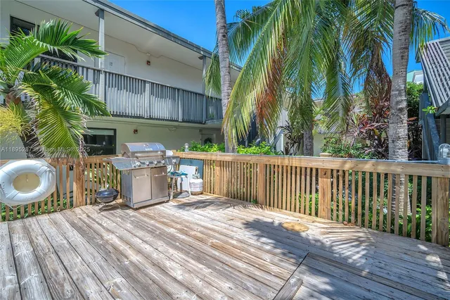 a view of a chairs and table on the wooden deck