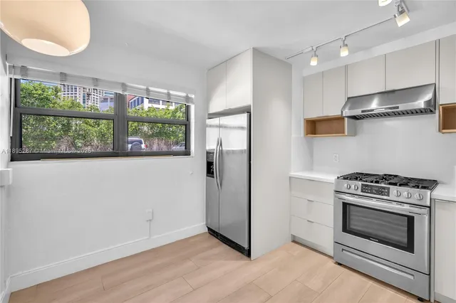 a kitchen with a stove and a refrigerator