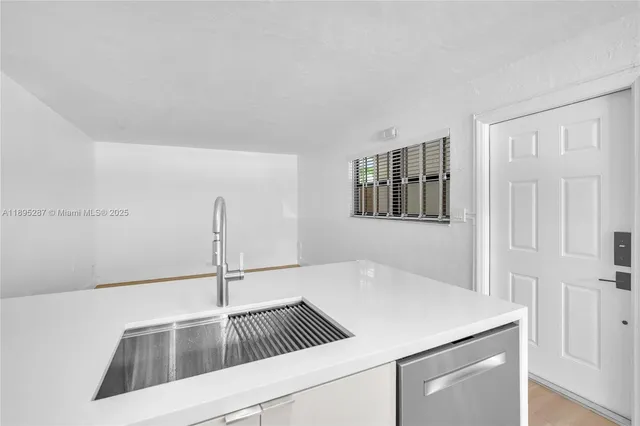 a kitchen with a sink and a refrigerator