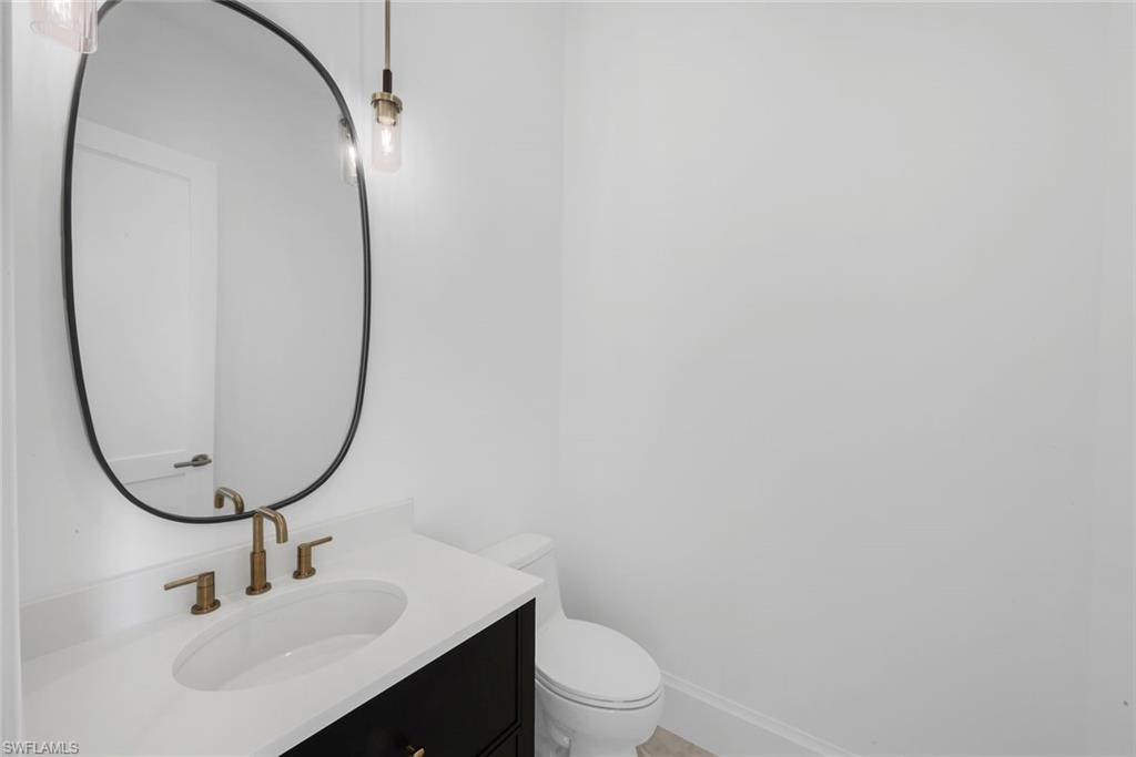 16728 Enclave Circle Naples, FL 34110 - Photo 25 of 49 Half bath featuring vanity and toilet