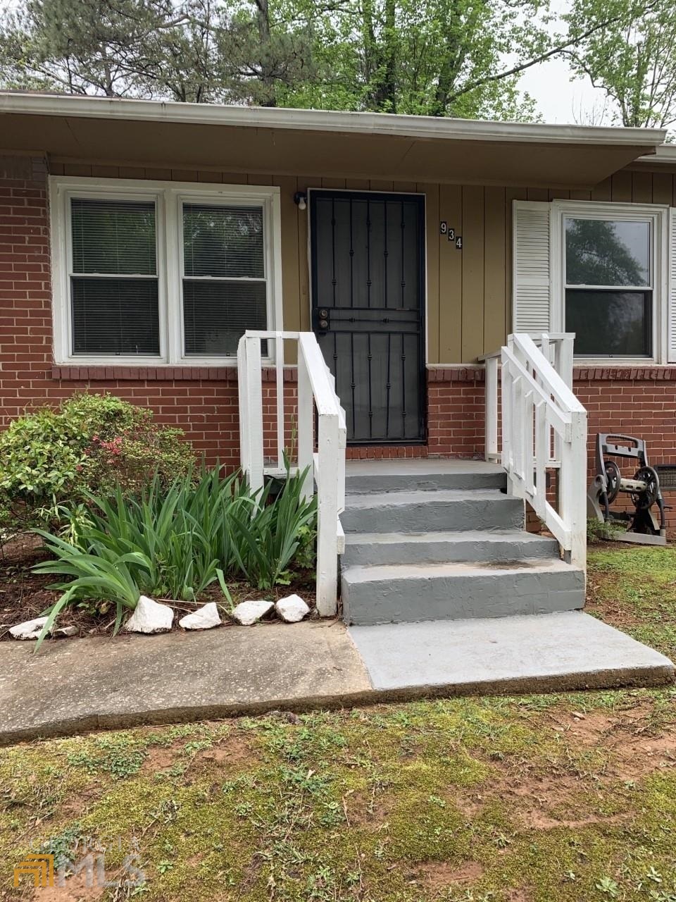 934 Northwest Fairburn Road Atlanta, GA 30331 - Photo 1 of 1 a front view of a house with a yard