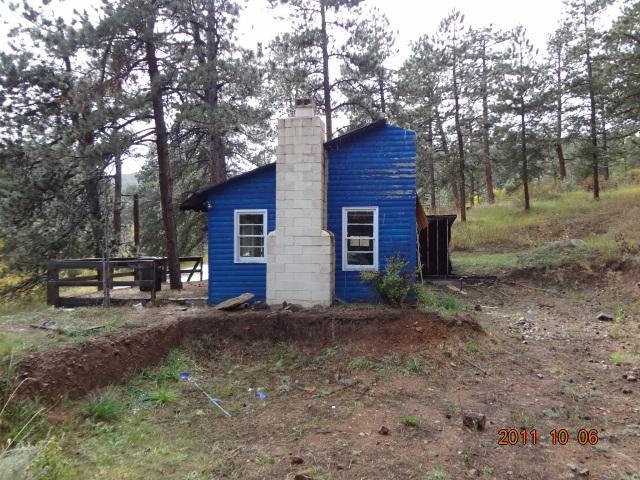 a view of a house with a yard and tree