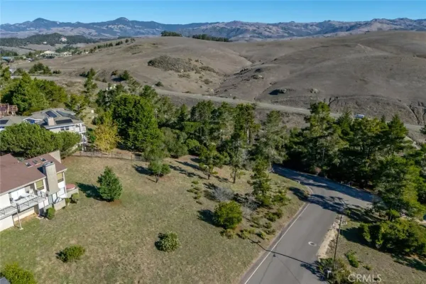 an aerial view of a houses with a yard