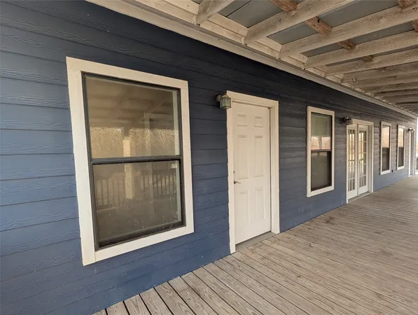 a view of a room with a chandelier and wooden floor