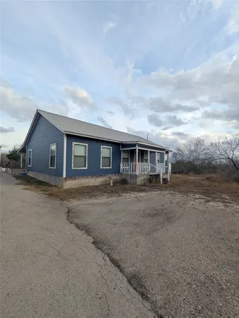 a front view of house with yard and car parked