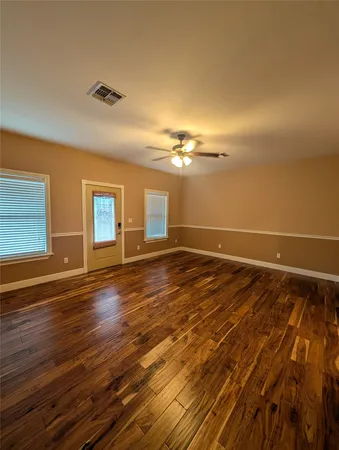 a view of room with window and ceiling fan