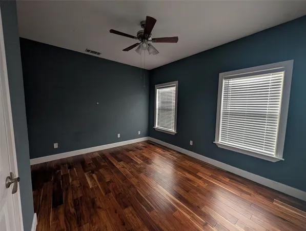 a view of room with window and hardwood floor