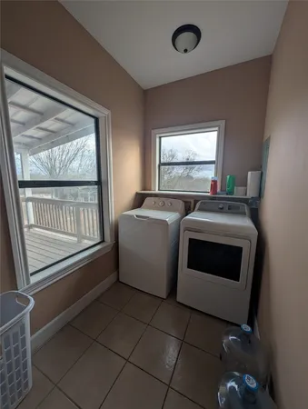 a spacious bathroom with a granite countertop sink a mirror and a shower