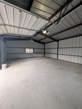 a view of dirt field with large trees