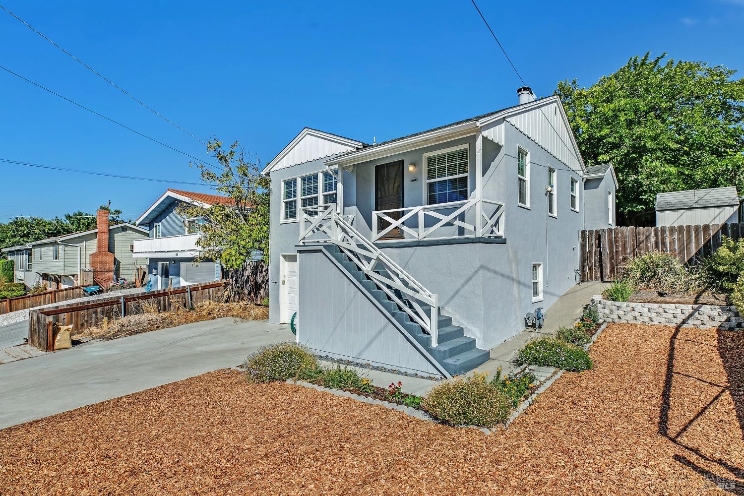 a view of a house with backyard and sitting area