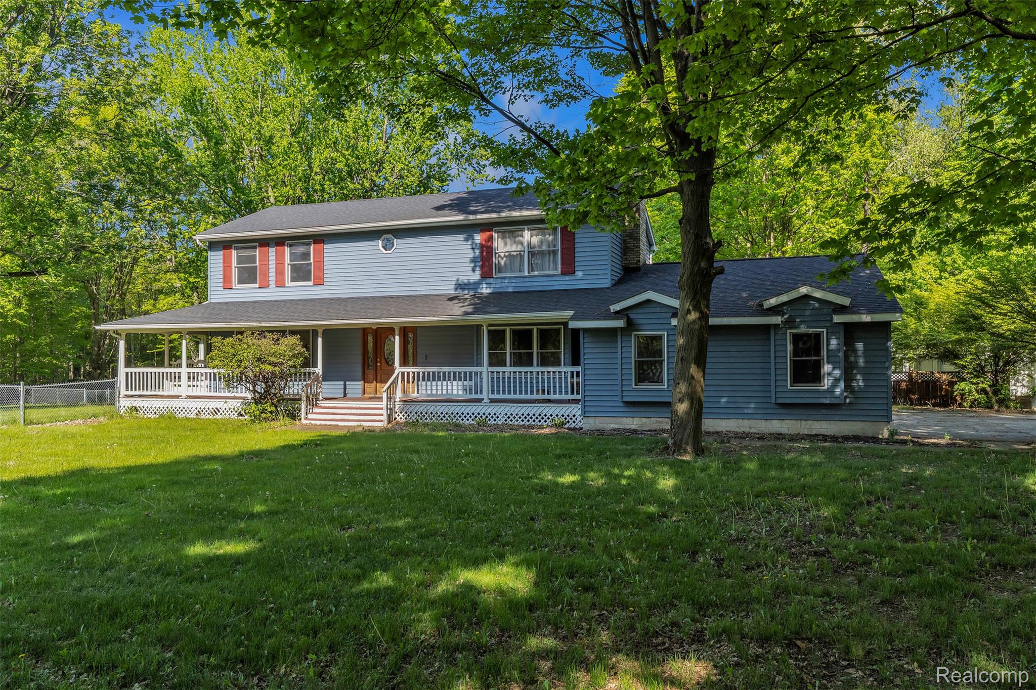 1345 Ives Road Mason, MI 48854 - Photo 90 of 92 View of front facade featuring a porch, a front lawn, and a shingled roof