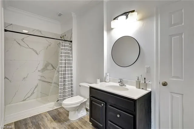 a bathroom with a sink toilet and shower