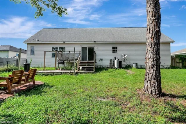 a view of a house with backyard and a chair