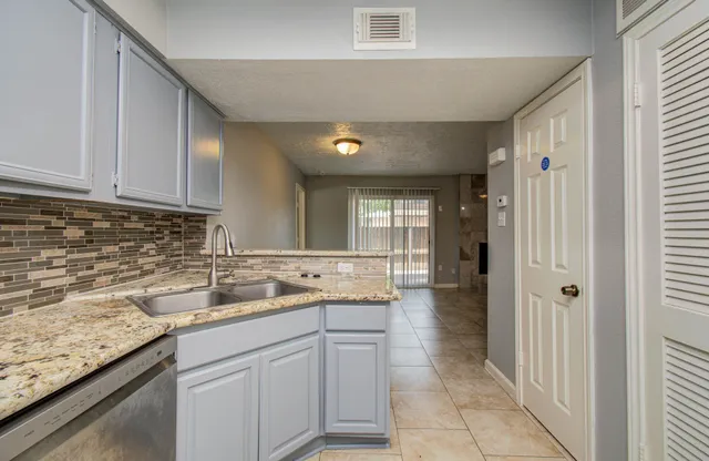 a kitchen with a sink stove and cabinets