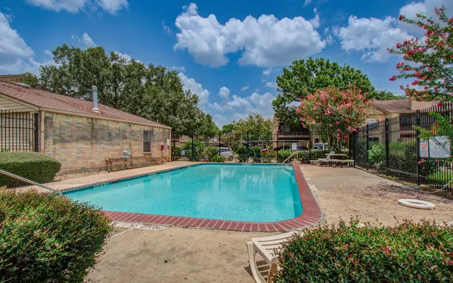 a view of a swimming pool with a yard