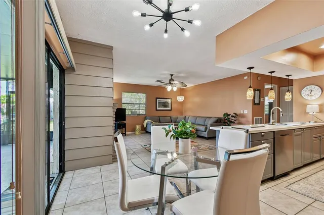 a kitchen with a sink a counter and chairs