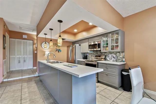 a kitchen with stainless steel appliances a sink a stove and a refrigerator