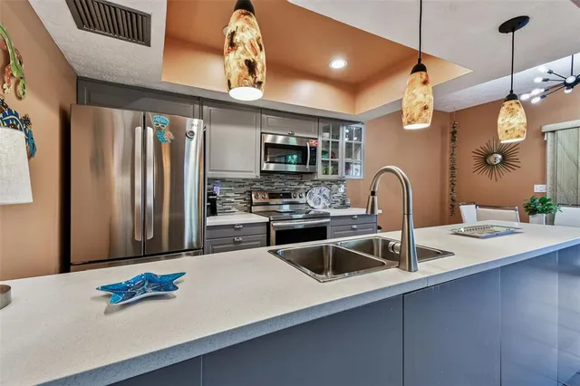 a dining room with furniture potted plants and wooden floor