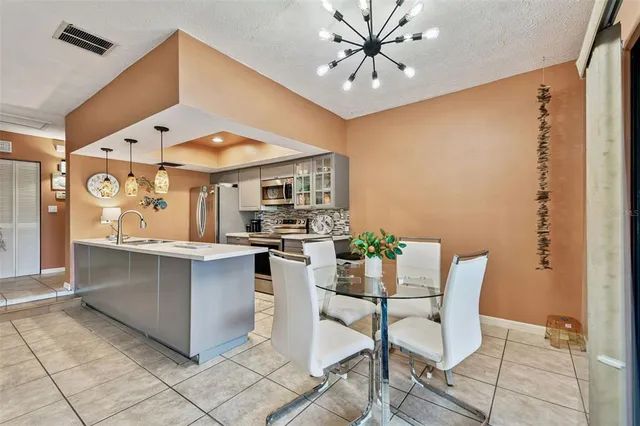 a view of a dining room kitchen island furniture and a chandelier
